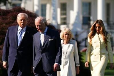 (L-R) US President Donald Trump, Britain's King Charles III, Britain's Queen Camilla and First Lady Melania Trump walk toward the White House Beehive for a tour on the South Lawn of the White
