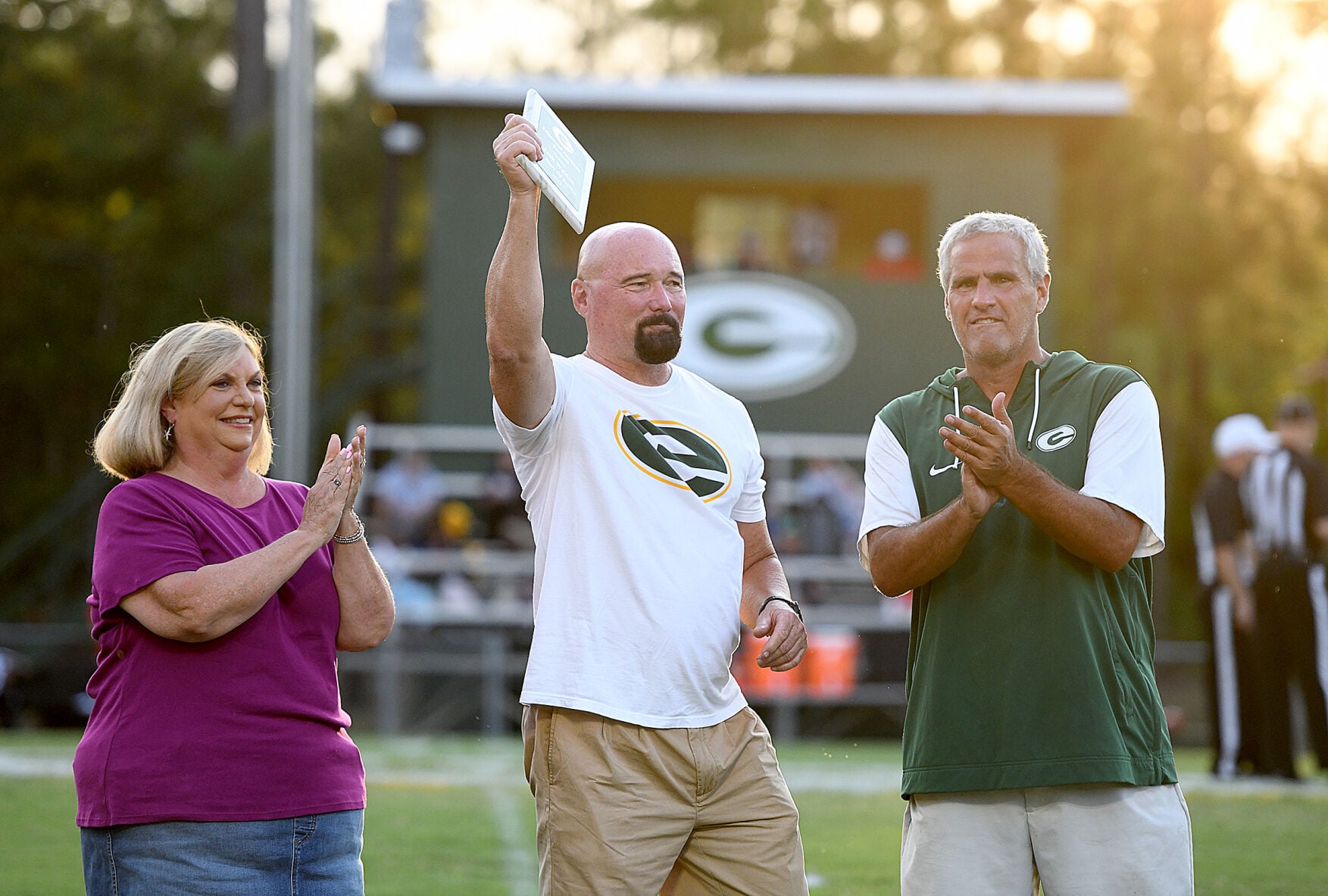 Cliff Williams / TPI Retired Edgewood assistant coach Jack Weldon, center, was honored before Friday’s game for his more than two decades of service to Edgewood. Weldon is pictured with Edgewood head of school Susan Barner, left, and athletic director Scott Phillips.