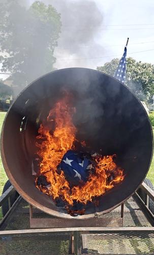 Scouts properly dispose of flags during ceremony