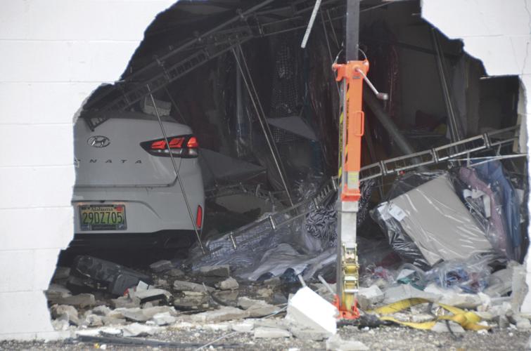 PHOTOS: No major injuries as car drives through building