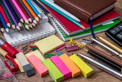 different school supplies on a wooden table