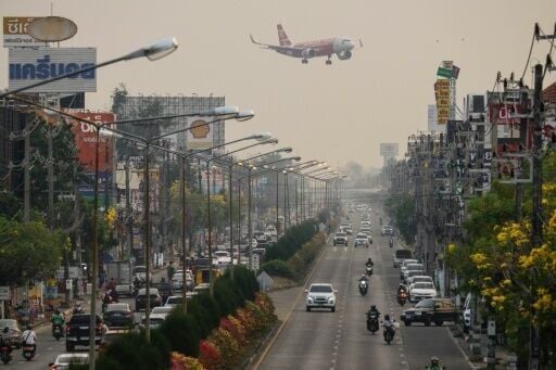A passenger plane prepares to land at Chiang Mai airport on a smoggy day