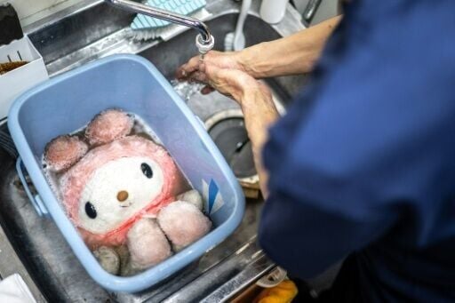 Dry-cleaning professional Masakazu Shimura cleans a soft toy at the facility of Cleaning Yonmarusan in Fuefuki city of Yamanashi Prefecture