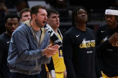 Injured Luka Doncic watches from the sidelines during his Los Angeles Lakers' NBA playoff series victory over the Houston Rockets