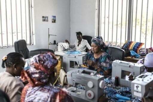 Women who lost family members at sea take part in a sewing class at the DDM offices in Mbour