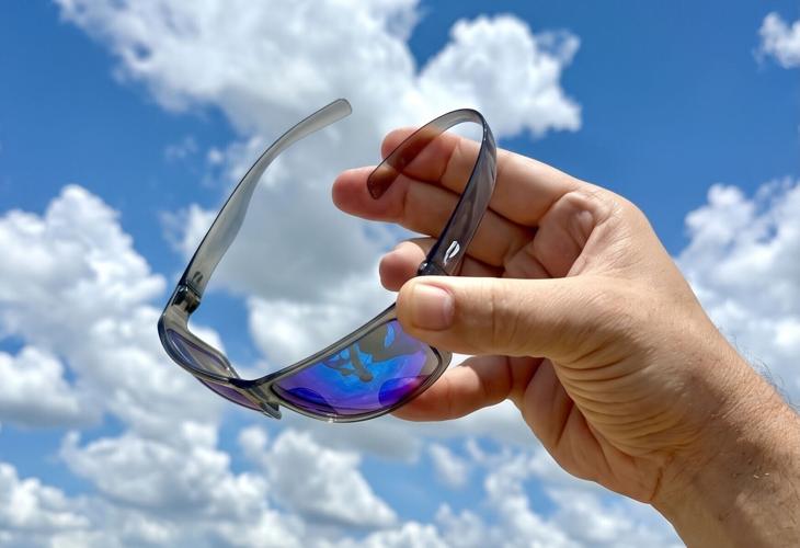 Kingfisher Sport in the new translucent gray with gradient mirrored sapphire lenses. Those temples bend like that because they are Resilamideâ„¢: 1mm thin, flexible, and shaped to wrap around your head instead of down around your ears. That is what lets t...