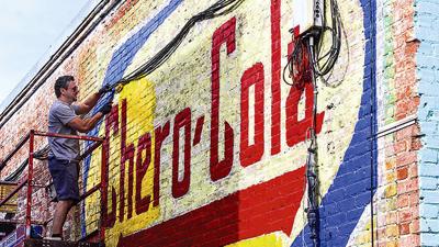 Forgotten drink company sign on side of historic building in Alex City is getting a fresh look