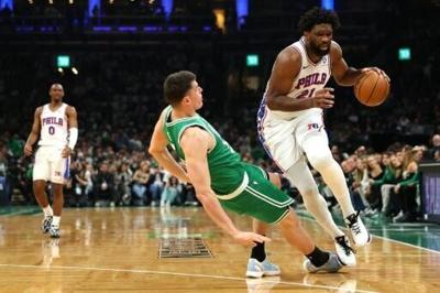 Philadelphia's Joel Embiid collides with Luka Garza of the Boston Celtics in the 76ers' series-clinching victory in the NBA Eastern Conference playoffs
