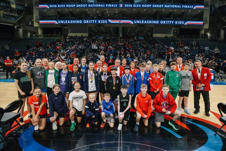 The 12-13-year-old Finalists pose with Regional Director volunteers and a crowd of their fans and family. The Getty Powell Award winners, who made the most regulation free throws of any other competitors, Logyn Parkinson and Duncan Walker, are near cent...