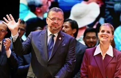Costa Rica's outgoing President Rodrigo Chaves (L) poses with Costa Rica's President-elect Laura Fernandez as she presents the members of her new Cabinet