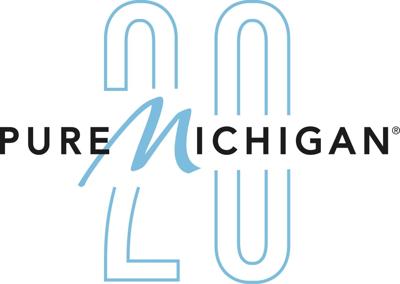Pure Michigan 20th anniversary logo. The word "Pure" is in black sans-serif type, followed by the word "Michigan." The "M" is in a light blue script with the rest of the word "Michigan" in the same black sans-serif font. A large, stylized number 20 in l...