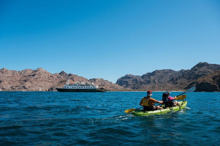 Kayakers explore the waters of Baja, Mexico with UnCruise Adventures