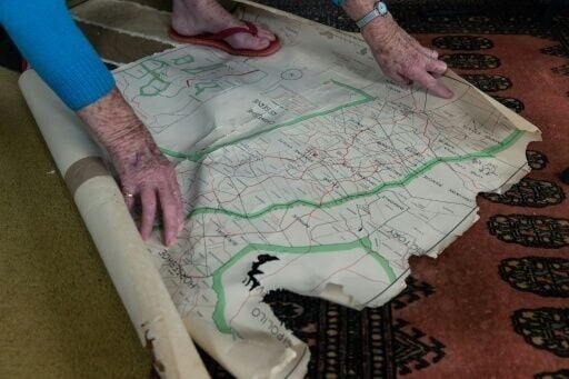 A farmer points to map of her farm boundaries in Mvurwi, repossessed during Zimbabwe's land reform programme