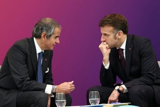 French President Emmanuel Macron speaks with Rafael Grossi, director general of the International Atomic Energy Agency, at a nuclear energy summit outside Paris