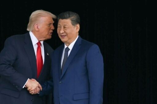 US President Donald Trump and Chinese President Xi Jinping shake hands as they leave after their talks in Busan, South Korea on October 30, 2025