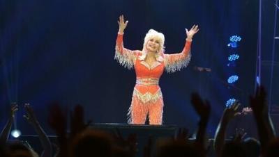 Dolly Parton, seen in a concert in 2014, is an American cultural icon