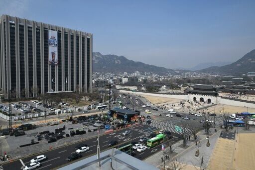 Workers set up the stage for a comeback concert of K-pop boy group BTS in front of the Gyeongbokgung Palace in central Seoul