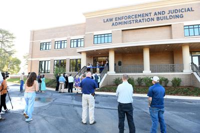 Cliff Williams / TPI Officials gather last week to cut the ribbon on the new Elmore County Law Enforcement and Judicial Administration Building. It will allow the renovation of the judicial complex to create more courtrooms for added judges.