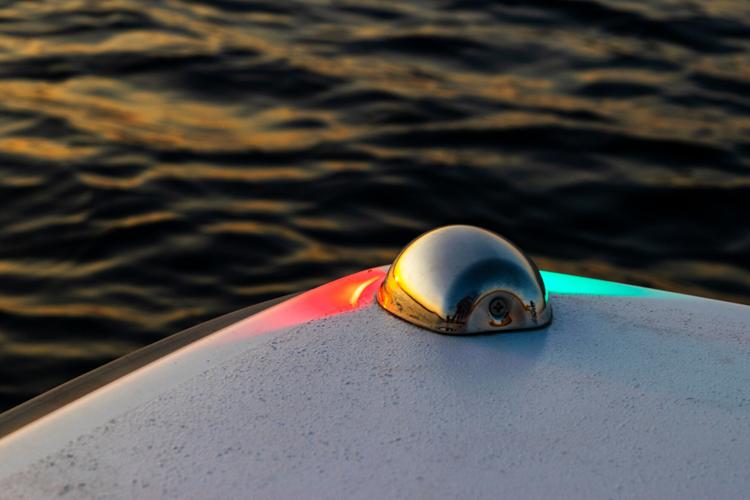 Red and green boat navigation lights. Marine navigation equipment. Glass signal light on the passenger fishing boat.