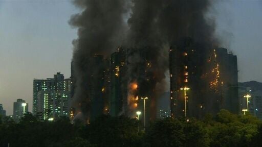 Thick smoke billows out of several high-rise blocks in a Hong Kong residential estate after a fire broke out, killing at 44 people