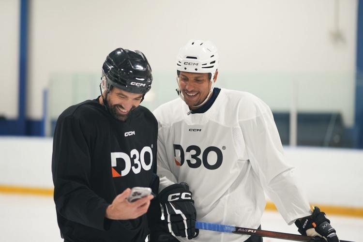 NHL Pro Hockey player Dakota Joshua and How to Hockey's Coach Jeremy, checking out the impact of their D3O phone protection test on the ice at Upper Canada College.