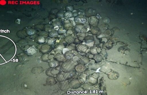 Soon the robot is gliding over piles of round pitchers on the sea floor