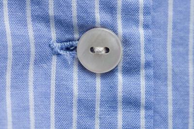 Is the person wearing the clothes fastening their own buttons?