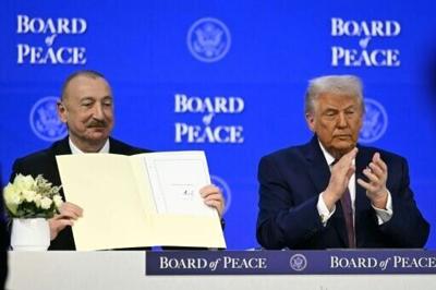 Azerbaijan's President Ilham Aliyev holds a signed founding charter of the "Board of Peace" as US President Donald Trump applauds during the World Economic Forum in Davos, Switzerland