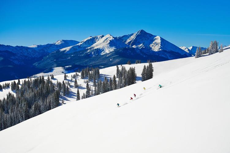 Skiers in Vail Mountain's Legendary Back Bowls.