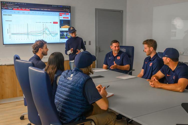Gretchen Oliver, professor and director of the Sports Medicine and Movement Laboratory, meets with members of the Auburn Baseball staff.