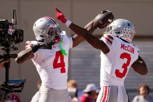 Ohio State Buckeyes wide receiver Jeremiah Smith (4) celebrates a touchdown with with wide receiver Devin McCuin (3) during the