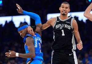 Oklahoma City's Shai Gilgeous-Alexander (2) and San Antonio's Victor Wembanyama (1) fight for position during Game 7 of the Western Conference Finals in the NBA playoffs between the Oklahoma City Thunder and the San Antonio Spurs at Paycom Center in 
