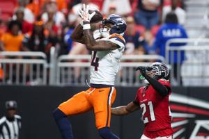 Denver Broncos wide receiver Courtland Sutton (14) catches a pass in front of Atlanta Falcons cornerback Mike Hughes (21) in the first quater at Mercedes-Benz Stadium in Atlanta on Aug. 14, 2026.