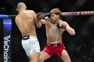 Jan 24, 2026; Las Vegas, Nevada, USA; Arnold Allen (red gloves) fights Jean Silva (blue gloves) during UFC 324 at T-Mobile Arena. Mandatory Credit: Stephen R. Sylvanie-Imagn Images