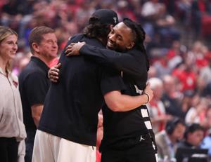 Cincinnati's Day Day Thomas shares a pregame hug with Texas Tech football player Brendan Sorsby before a Big 12 Conference men's basketball game, Tuesday, Feb. 24, 2026, in United Supermarkets Arena.