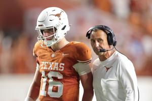 Texas head coach Steve Sarkisian speaks with quarterback Arch Manning during the fourth quarter against Ohio State at Darrell K Royal-Texas Memorial Stadium on Sept. 12, 2026, in Austin, Texas.