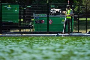 Crews clean up algae that began to grow in the Reflecting Pool days after the Trump administration’s at least $13 million
