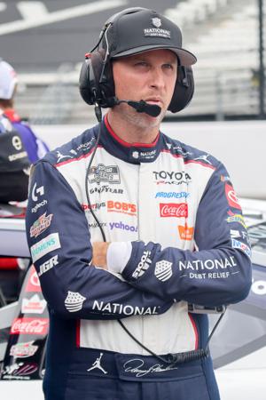 NASCAR Cup Series driver Denny Hamlin (11) stands next to his car Saturday, July 25, 2026, during qualifying for the Brickyard