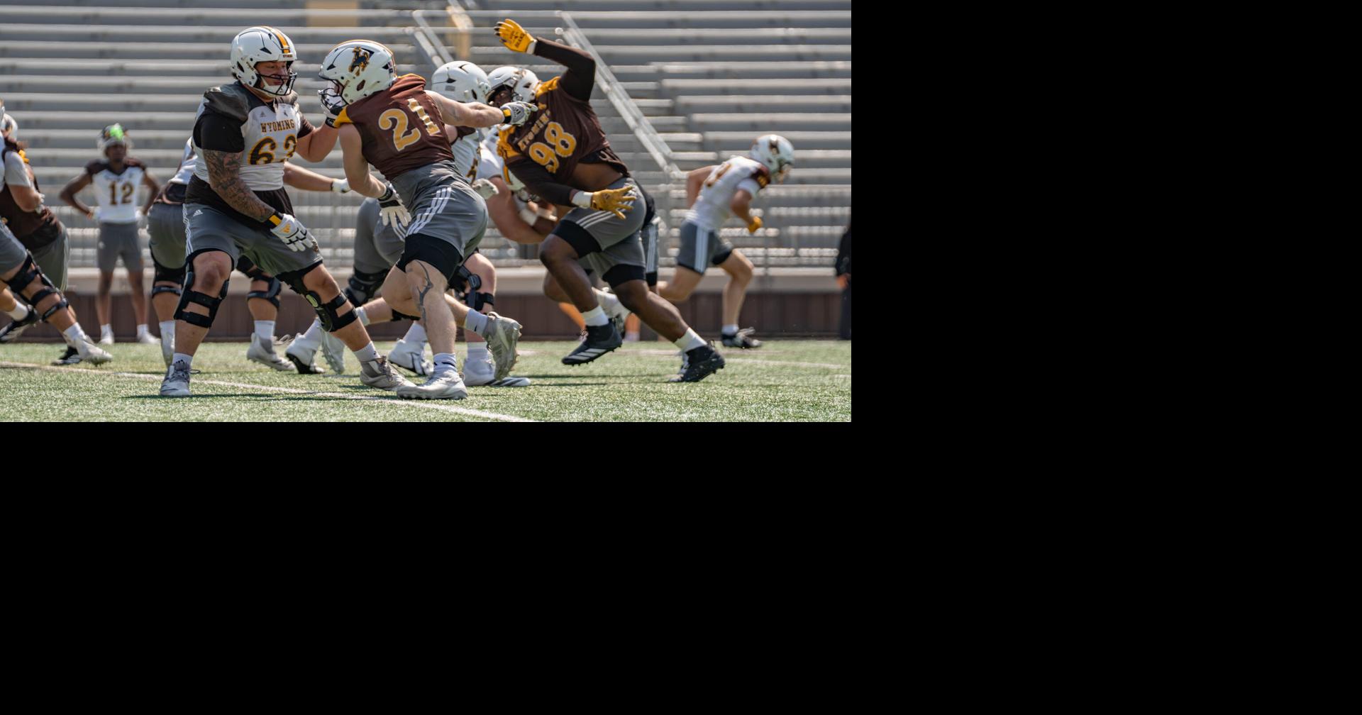 Wyoming's fall camp opens with a major line shakeup, and a new quarterback battle emerges