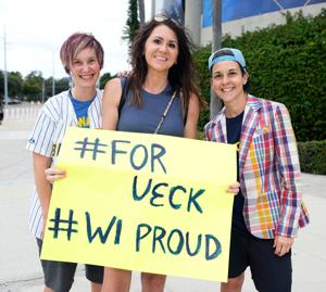 From left Susan Collyard, Maggie Klatt, and Shanna Maloney hold up a sign for Bob Uecker before Game 5 of the World Series