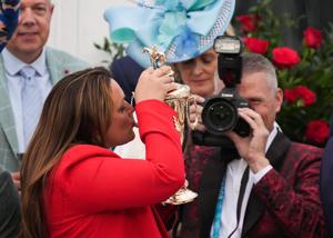 Trainer Cherie DeVaux kisses the trophy after her horse Golden Tempo with Jose L. Ortiz won the 2026 Kentucky Derby at Churchill