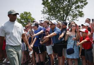Fans cheer as Tiger Woods makes his way to the 11th tee during the third round of the Memorial Tournament on Saturday, June 1,