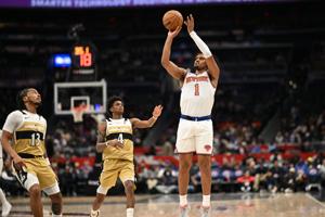 Feb 3, 2026; Washington, District of Columbia, USA; New York Knicks forward Dillon Jones (1) attempts a jump shot in front of Washington Wizards guard AJ Johnson (4) and guard Sharife Cooper (13)  during the fourth quarter at Capital One Arena. Manda