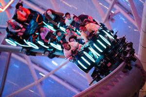 Magic Kingdom visitors hang on during the Tron Lightcycle/ Run coaster during a Disney After Hours event at Magic Kingdom theme park.