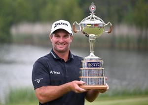 Ryan Fox celebrates with the trophy after defeating Sam Burns after four playoff holes at the 2025 RBC Canadian Open.