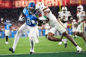 Ole Miss Rebels tight end Dae'Quan Wright (8) scores a touchdown past Miami Hurricanes defensive back Ja'Boree Antoine (16) during their Vrbo Fiesta Bowl matchup at State Farm Stadium on Jan. 8, 2026.