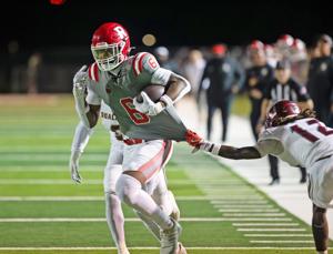 Ruston's Ahmad Hudson running with the ball against a Ouachita Lion defender, Friday, October 10, 2025, Hoss Garrett Stadium, Ruston, LA.