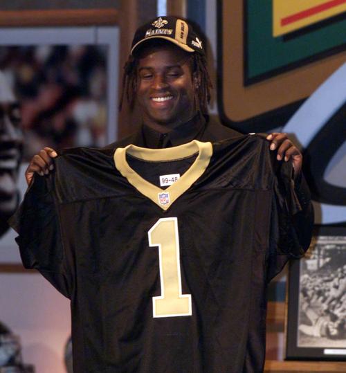 Heisman Trophy winner Ricky Williams, running back from Texas, shows off his New Orleans Saints jersey after being picked fifth in the NFL draft Saturday, April 17, 1999.