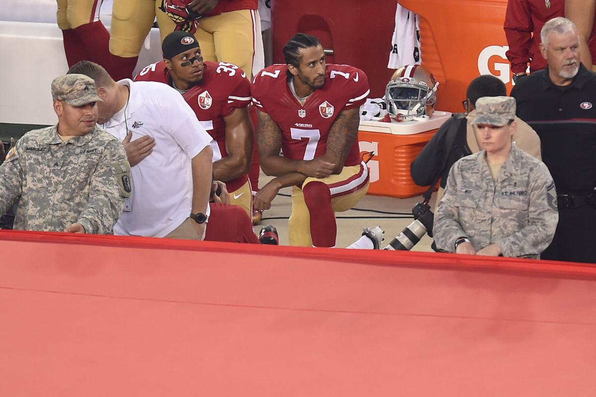 San Francisco 49ers quarterback Colin Kaepernick (7) and Eric Reid (35) kneel down during the playing of the national anthem before their NFL game on Monday, Sept. 12, 2016 at Levi's Stadium in Santa Clara, Calif.