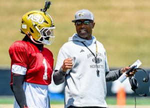 Head coach Eddie Robinson, Jr., works with quarterback Andrew Body (1) during an Alabama State University football scrimmage at ASU Stadium in Montgomery Ala., on Saturday August 16, 2025.